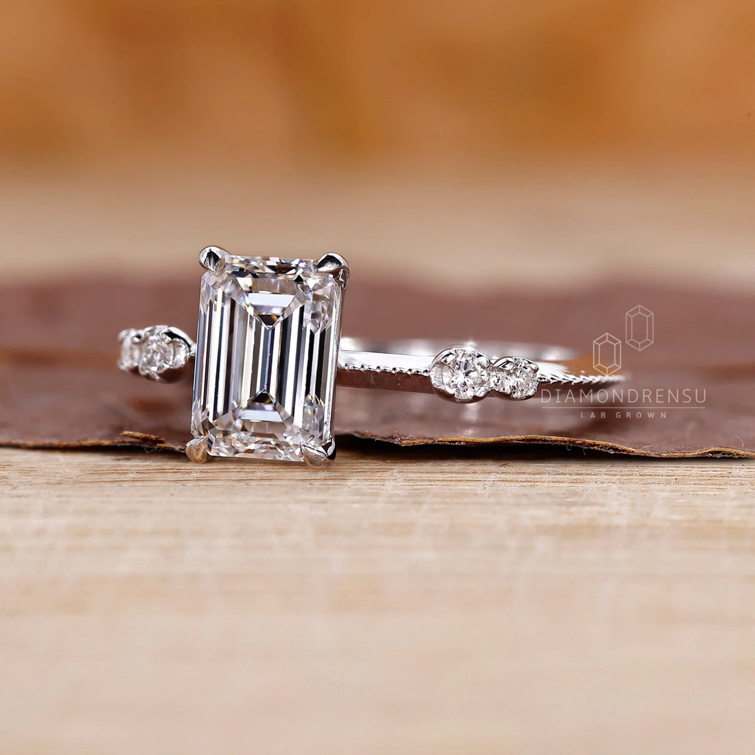 White Gold Emerald Ring With Knife Edge Shank Band