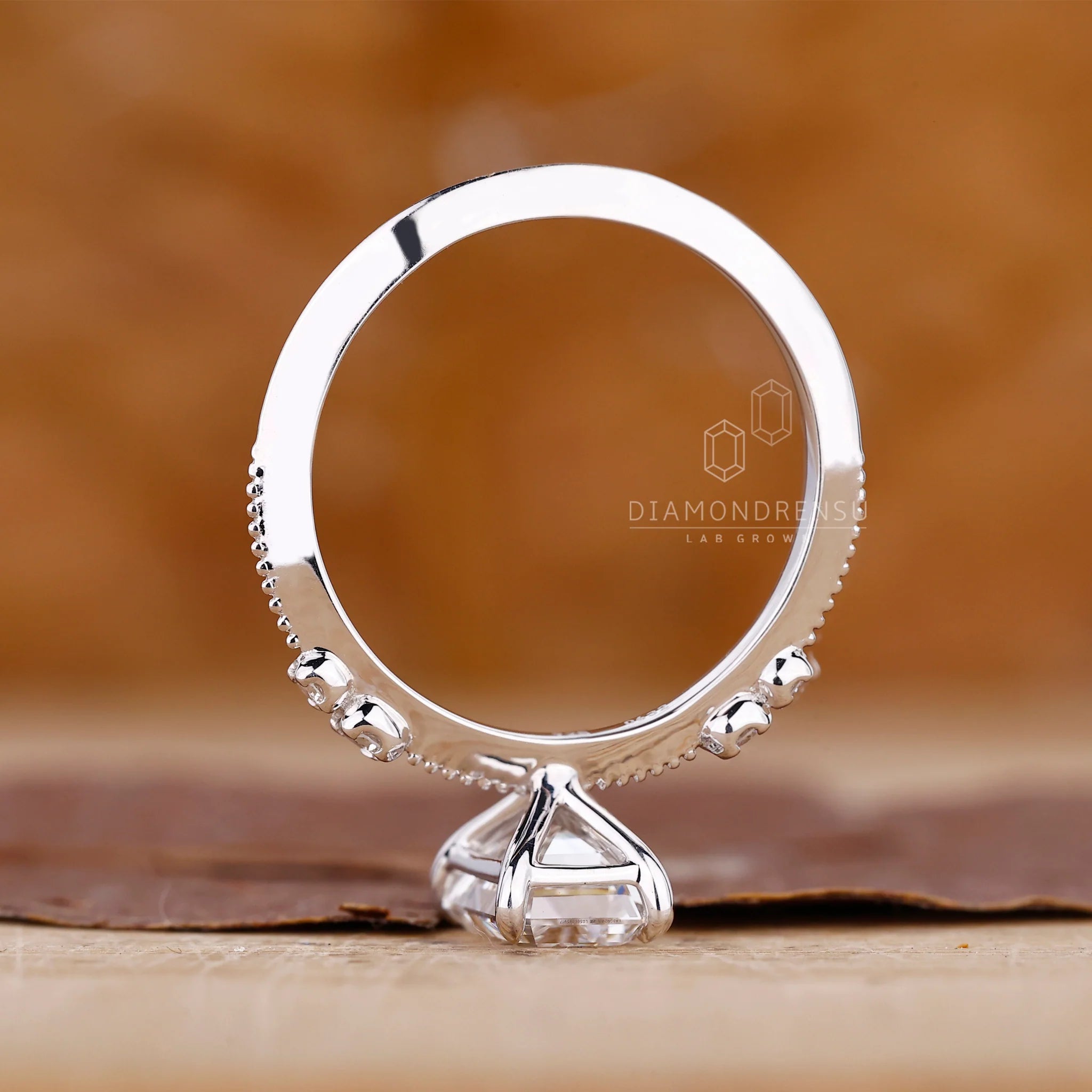 White Gold Emerald Ring With Knife Edge Shank Band