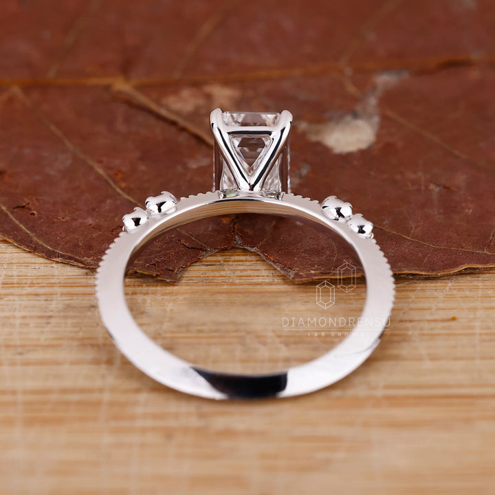 White Gold Emerald Ring With Knife Edge Shank Band